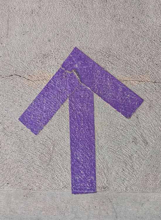 purple arrow pointing up on concrete
