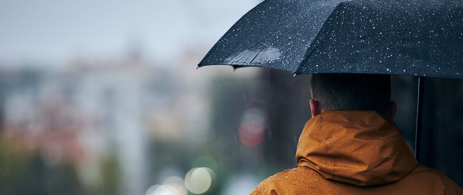 Image of man under an umbrella