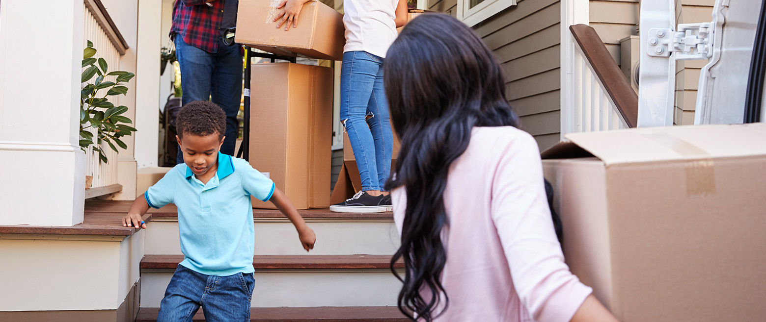 Family moving boxes into their new home