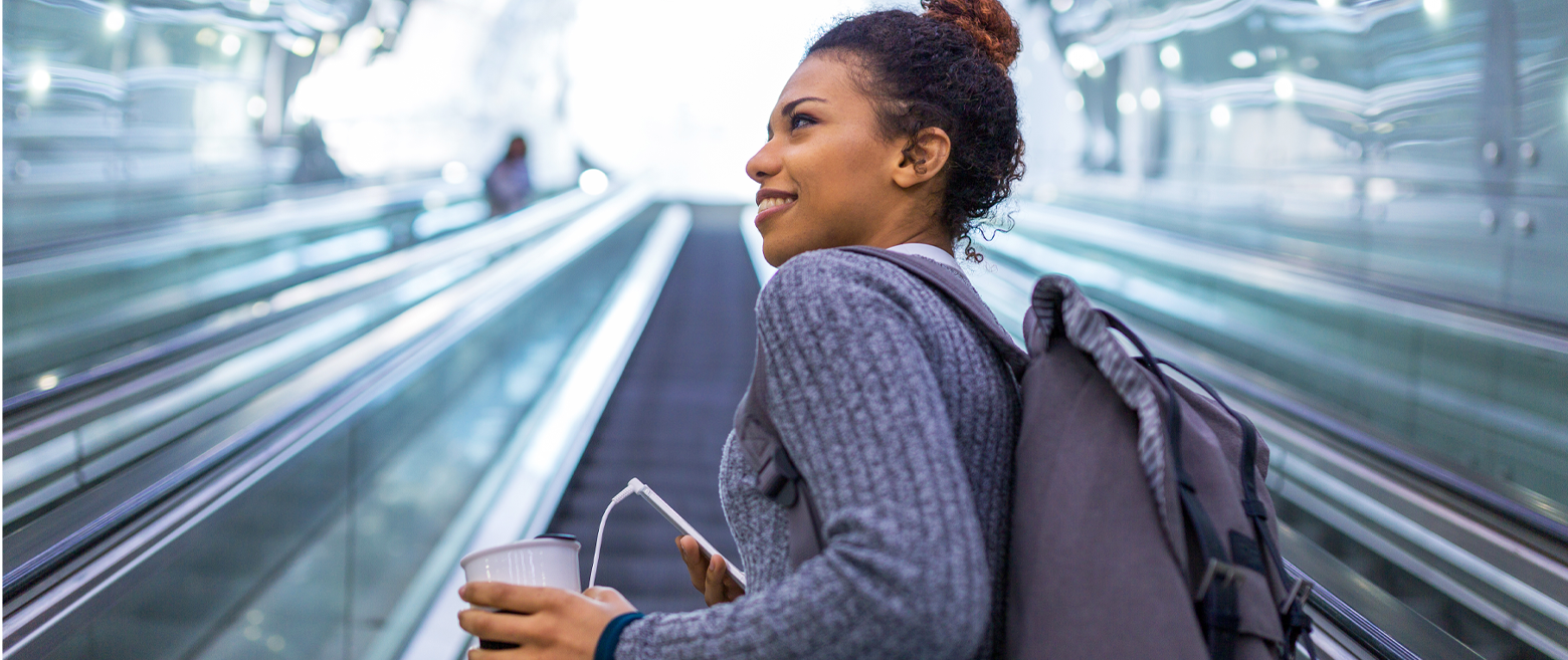 Woman going up an escalator.