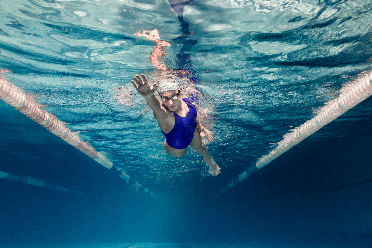 Lady swimming in a pool lane