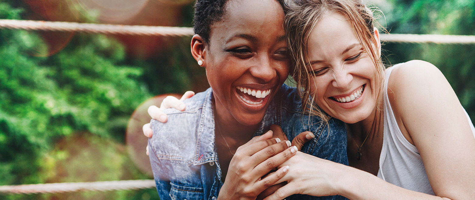 Two women hugging and smiling