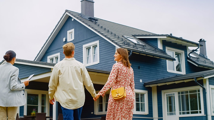 Couple looking at a house for sale with a realtor