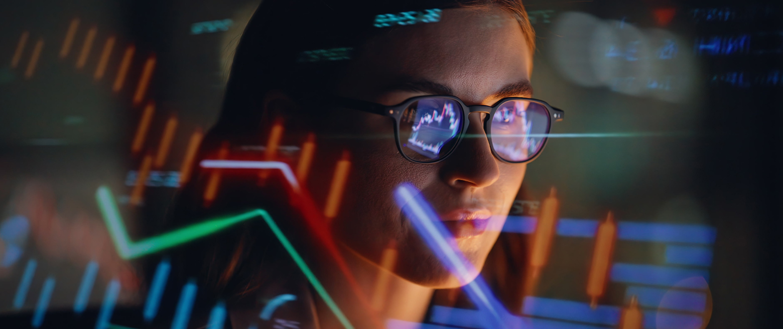 Reflection of woman viewing trading screen