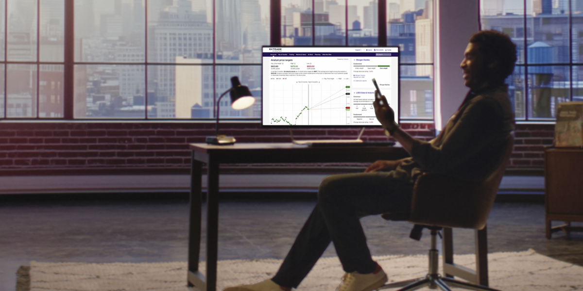 Man on computer looking at E*TRADE platform