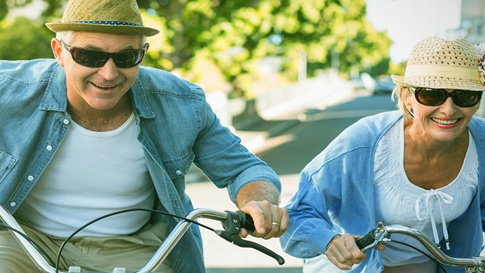Couple biking together smiling