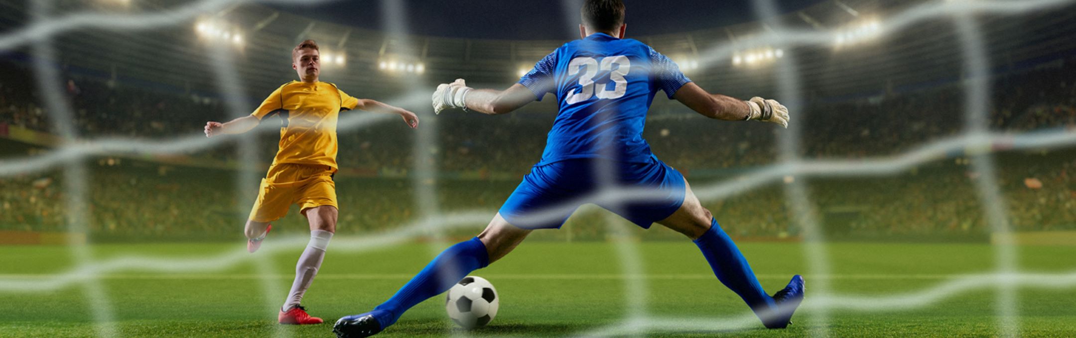 a view from behind the football goals with two players