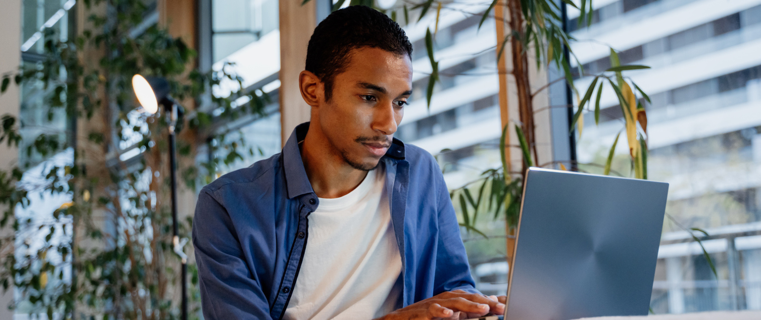 man looking at a laptop