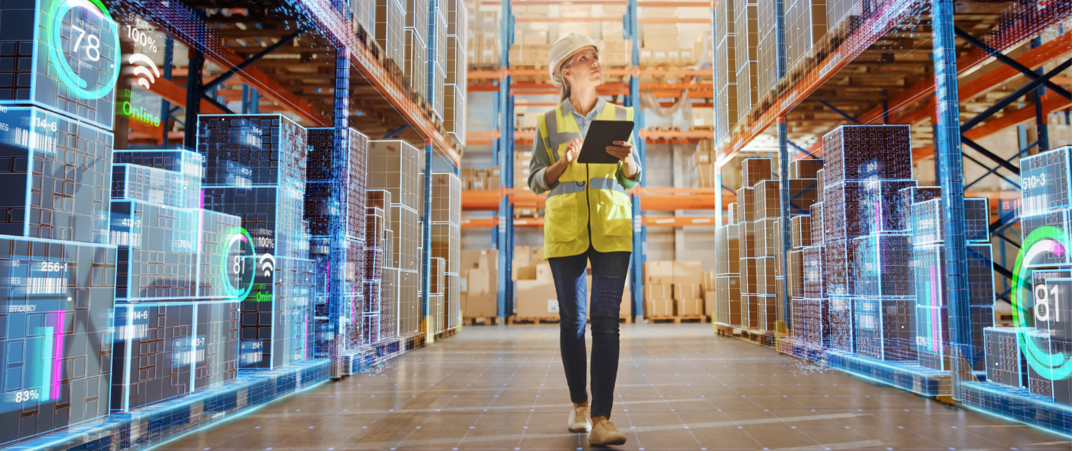Women with hardhat on and tablet walking in an isle in a digital warehouse