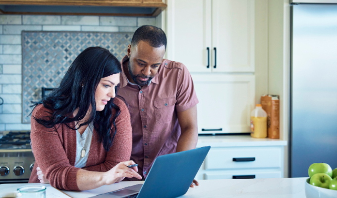 Woman and man look at computer