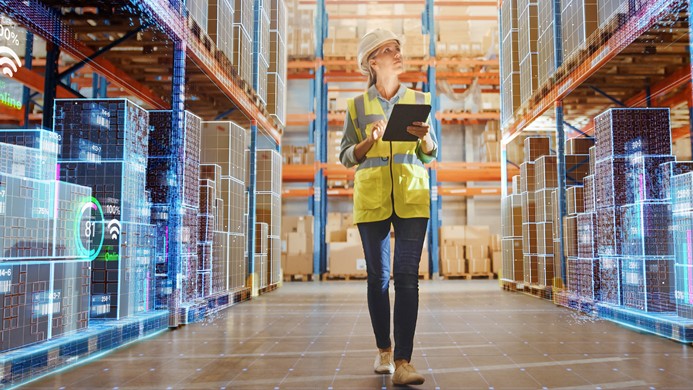 Woman in yellow vest looking at inventory