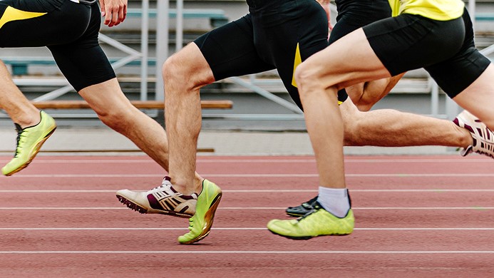 Runners racing with track shoes shown