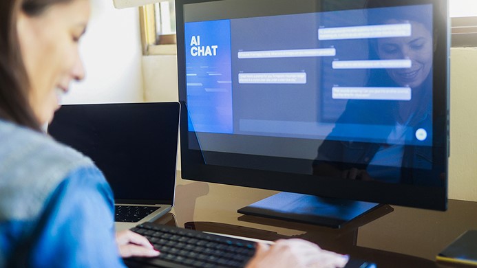 Woman looking at AI chat screen on a computer