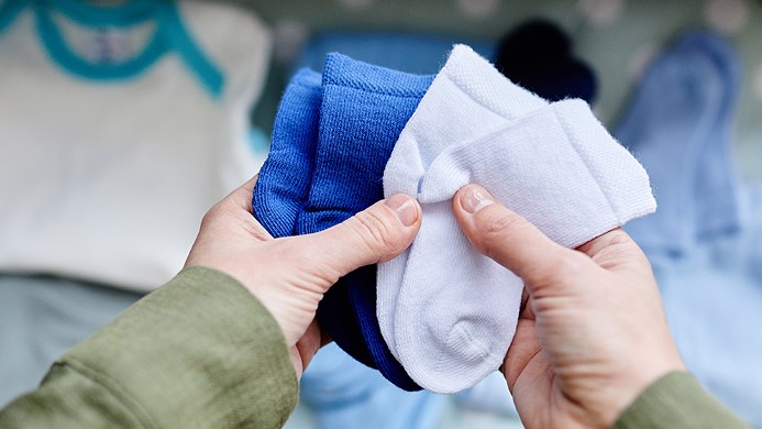 Person holding baby socks