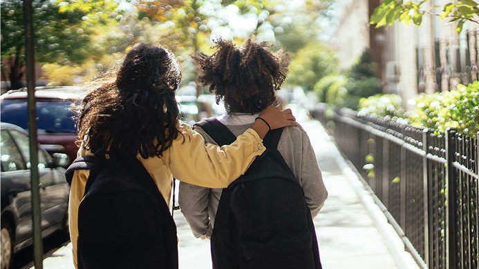 Two kids walking to school
