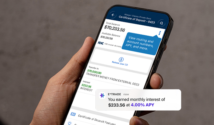 E*TRADE mobile app showing a Bank CD account with transfers in and a pop up notification that mentions a user earned monthly interest of $233.45 at 4.00% APY
